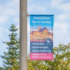Street Banner Basic with banner arm, attached to a lamp post