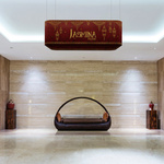 Rectangular curved ceiling hanger as a decorative element in the lounge area