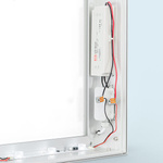 Power supply mounted concealed within the frame, frame including cable gland