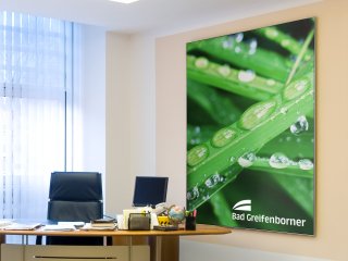 Textile poster with wall frame in the office